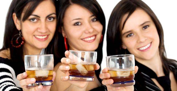 Three women with whisky on ice